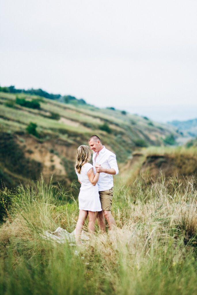 a guy with a girl in light clothes on the background of a green