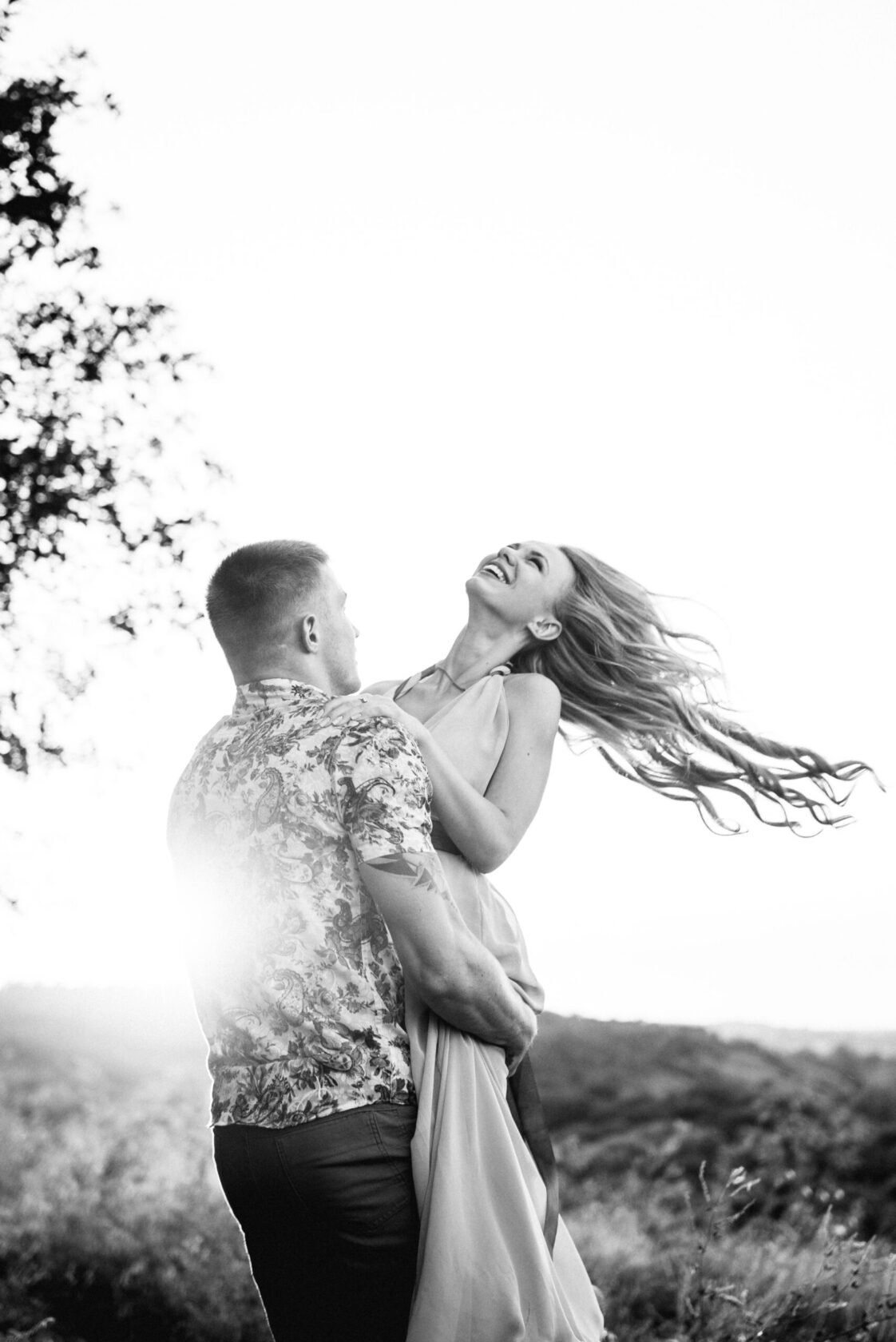 blonde girl with loose hair in a light blue dress and a guy in t