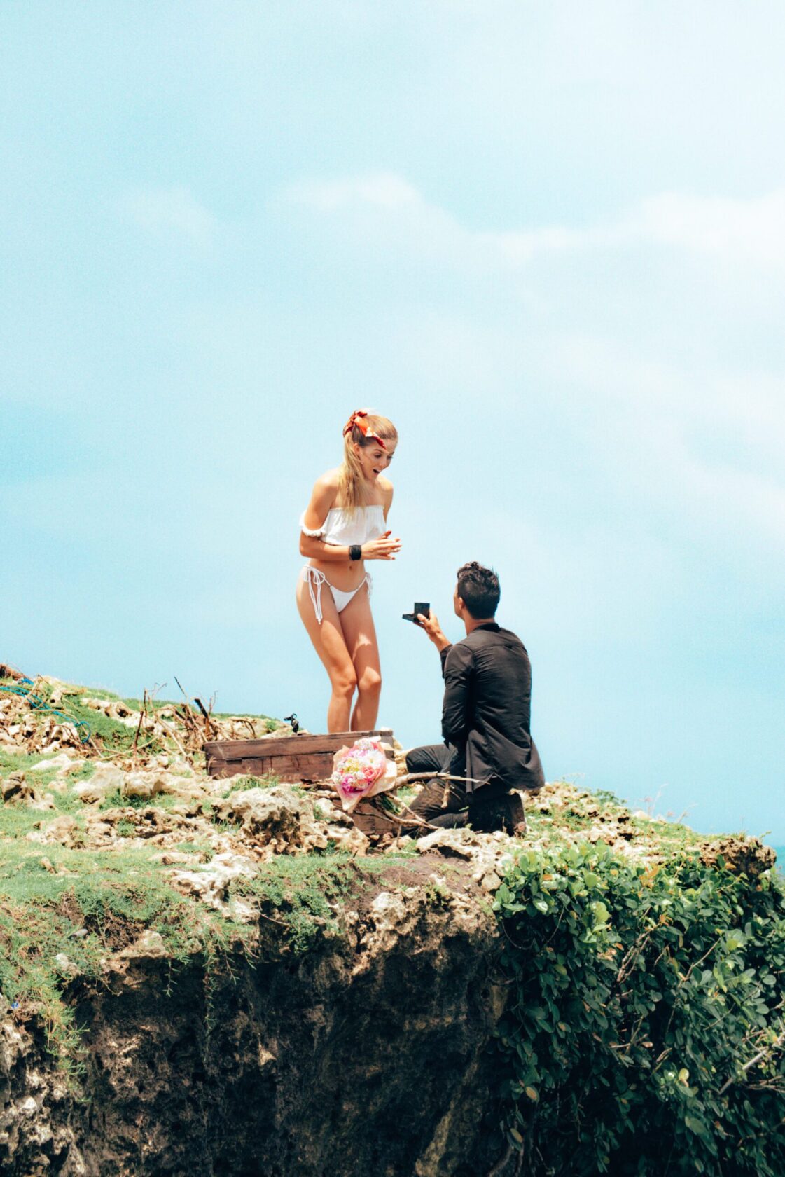 a guy with a girl in light clothes on the background of a green