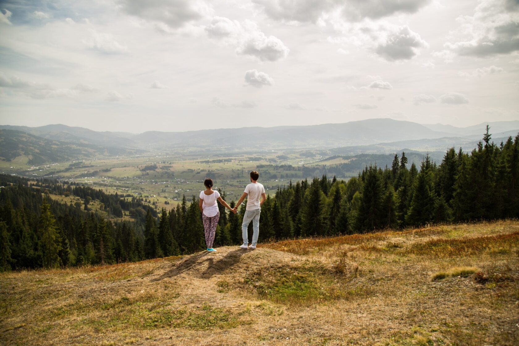 young-couple-holding-hands-and-watching-a-scenery-2024-09-17-11-45-54-utc